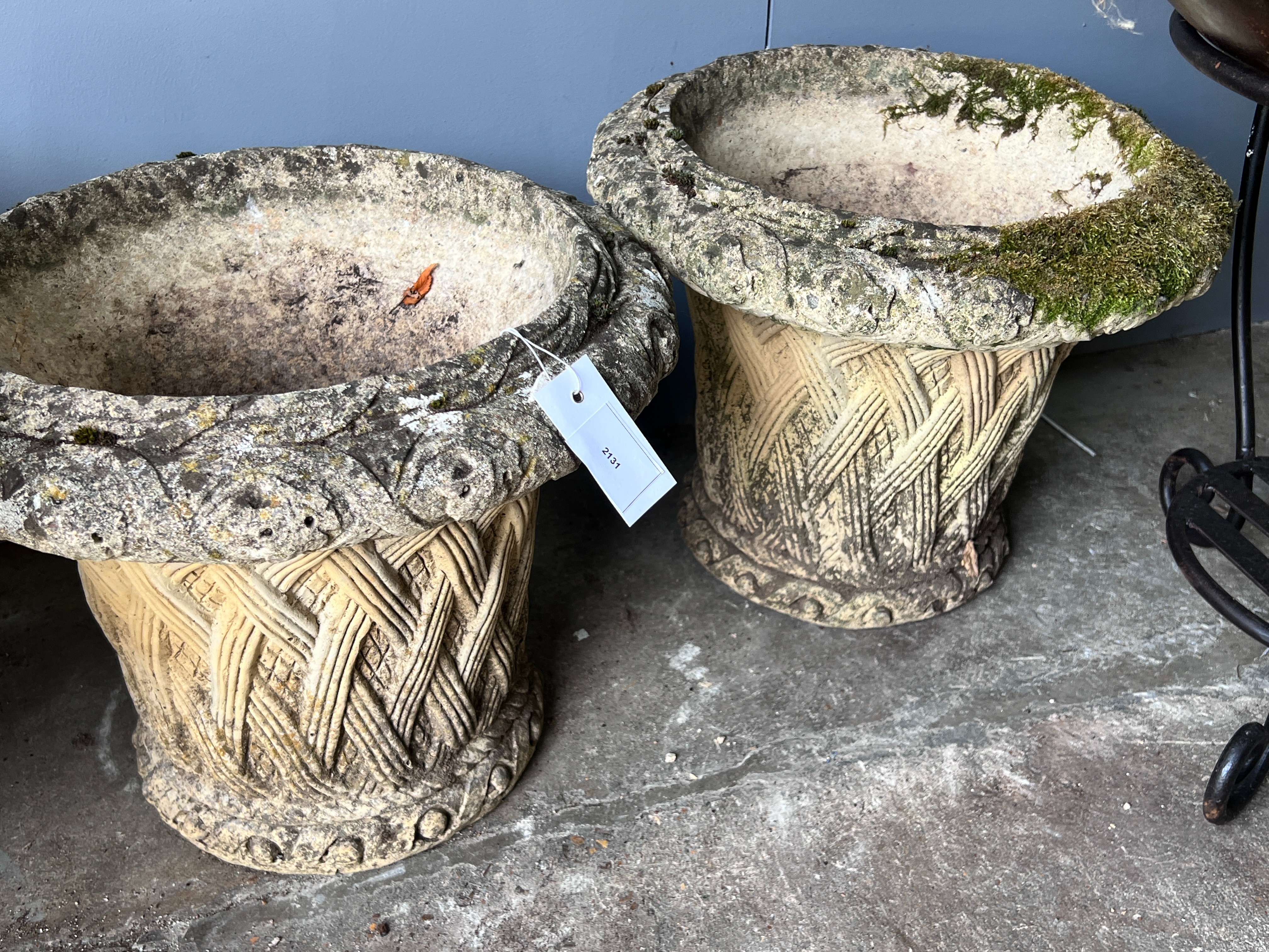 A pair of circular reconstituted stone basket weave effect garden planters, diameter 38cm, height 32cm